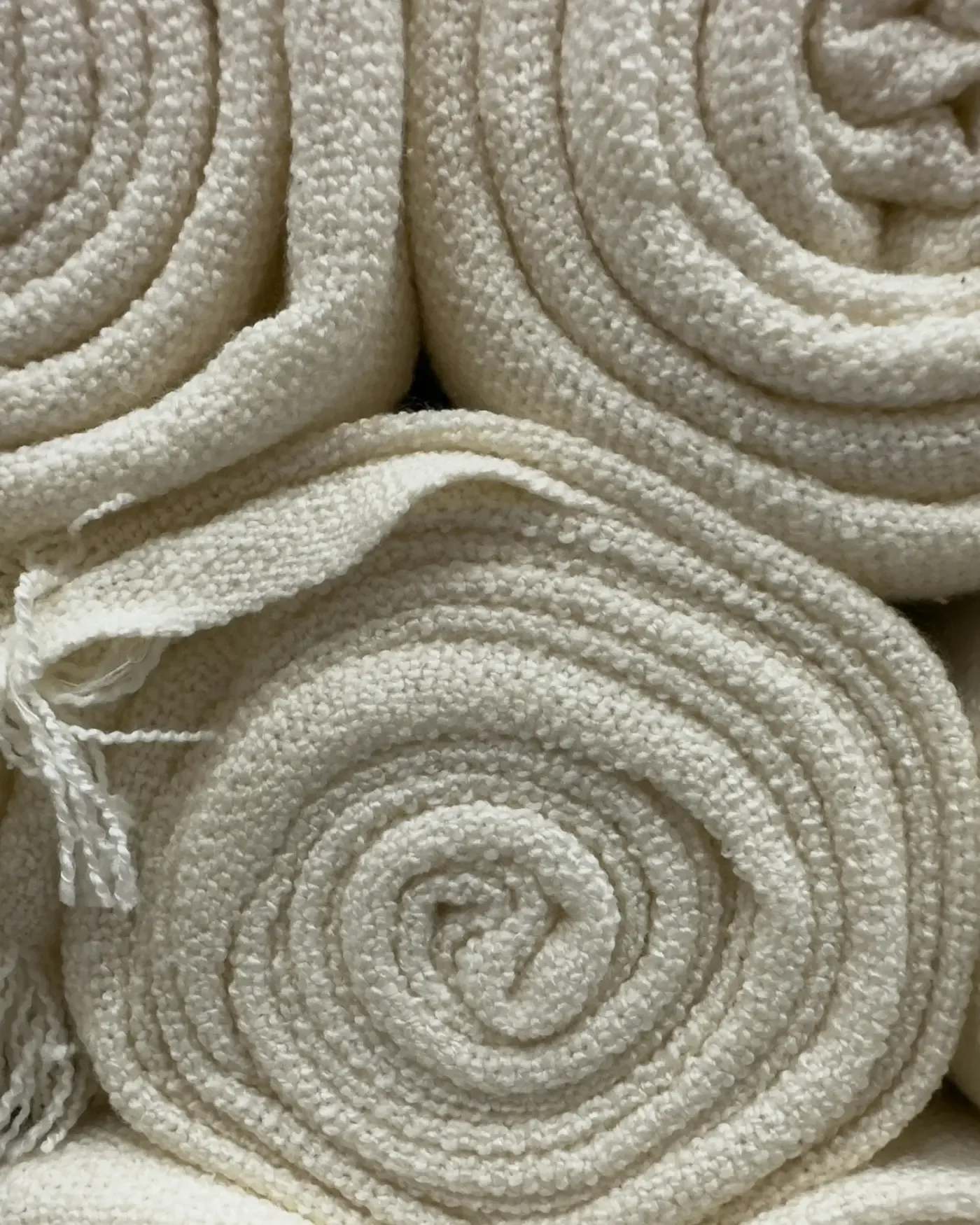 Soft rolled-up towels in cream tones — illustrating recovery